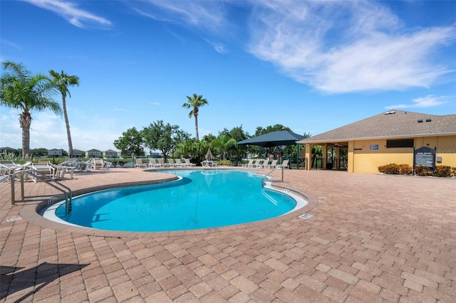 pool featuring a patio area and fence