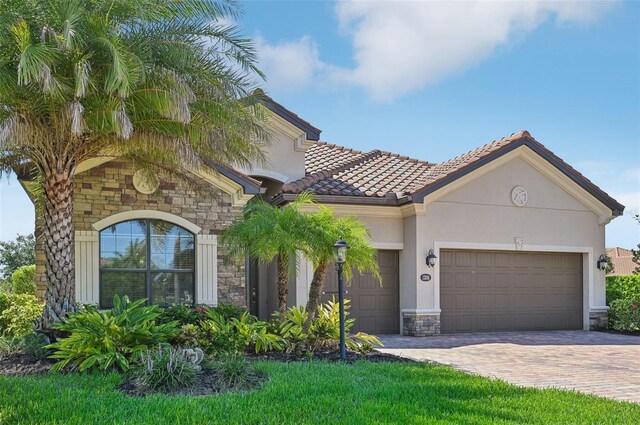 mediterranean / spanish-style home with a garage