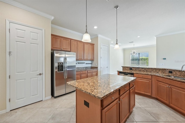 kitchen with decorative light fixtures, sink, ornamental molding, a center island, and stainless steel fridge with ice dispenser