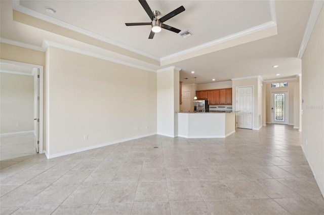 unfurnished living room featuring crown molding, light tile patterned floors, a tray ceiling, and ceiling fan