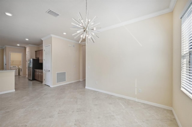 unfurnished living room with crown molding, a healthy amount of sunlight, an inviting chandelier, and independent washer and dryer