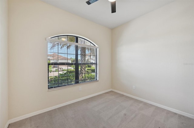 carpeted empty room featuring ceiling fan