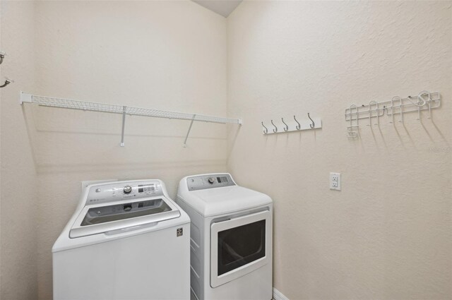 washroom featuring washer and dryer