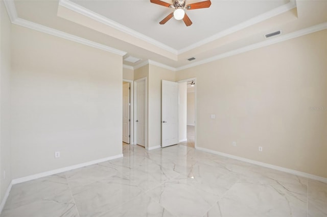 unfurnished bedroom featuring crown molding and a tray ceiling