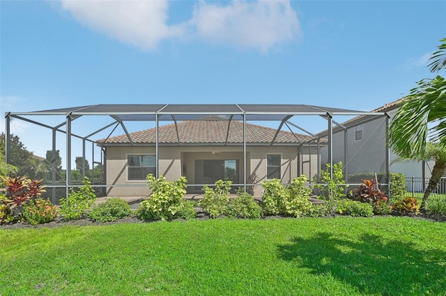 back of house with a lanai and a lawn