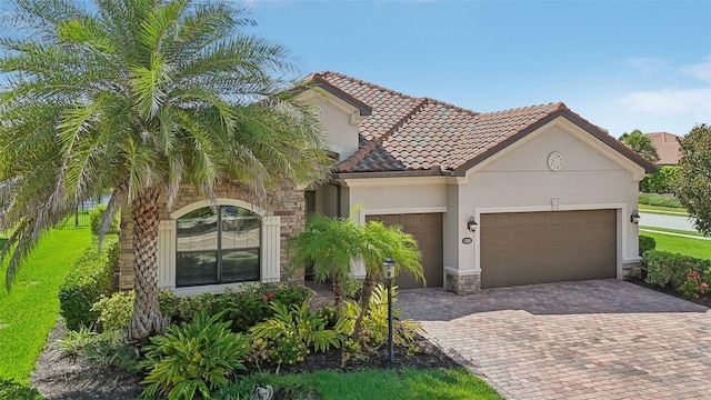 mediterranean / spanish-style house with a garage