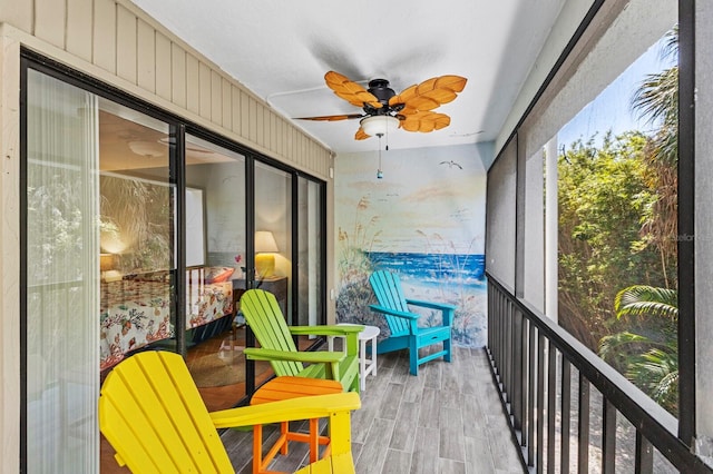 sunroom featuring ceiling fan