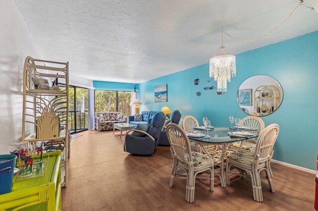 dining area featuring a notable chandelier, hardwood / wood-style flooring, and a textured ceiling