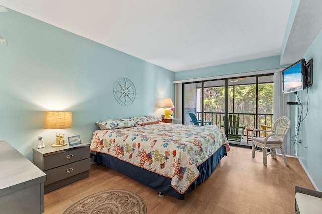 bedroom with access to exterior and light hardwood / wood-style flooring