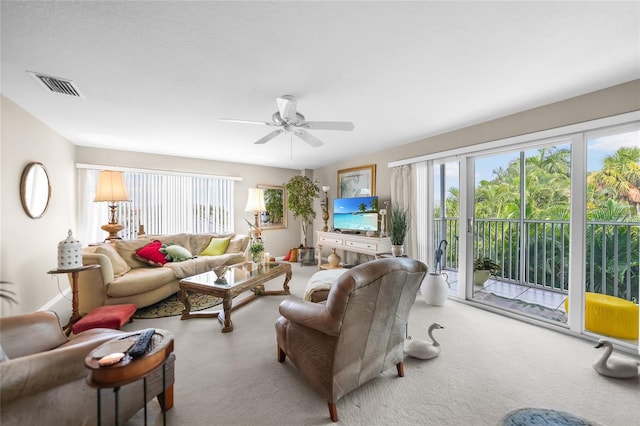 carpeted living room featuring ceiling fan