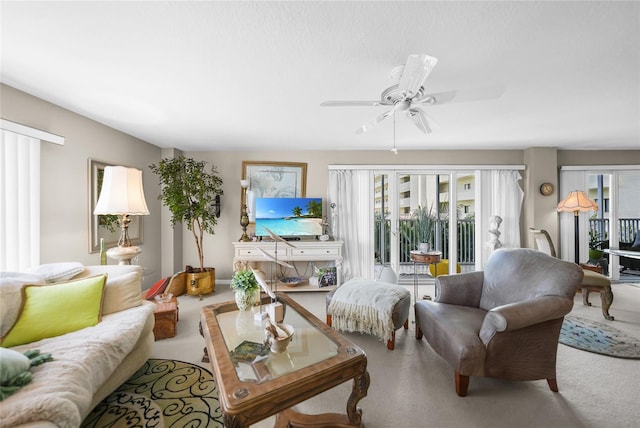 carpeted living room with ceiling fan