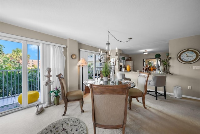 dining room featuring an inviting chandelier, a wealth of natural light, and light colored carpet