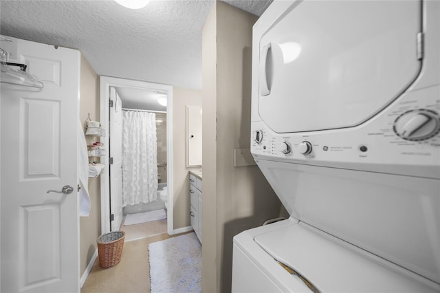 laundry area with stacked washing maching and dryer and a textured ceiling