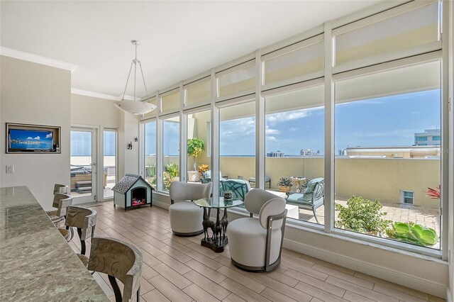 living room featuring light hardwood / wood-style flooring and ornamental molding