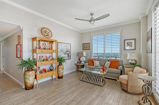 sitting room featuring ceiling fan, ornamental molding, and light wood-type flooring