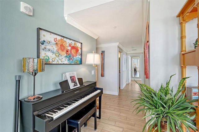 misc room with light hardwood / wood-style flooring and ornamental molding