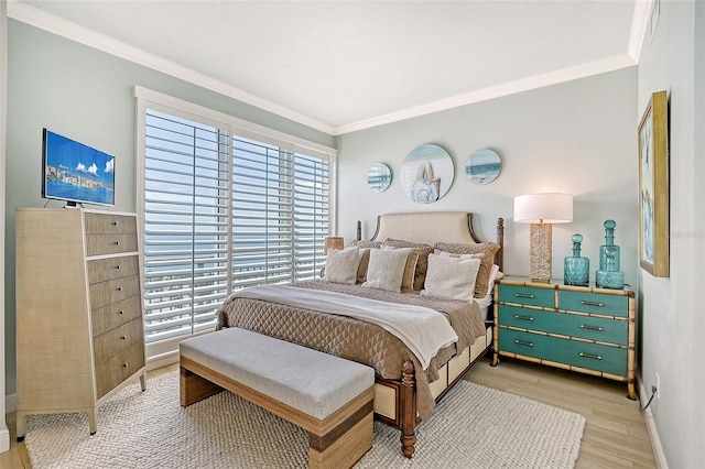 bedroom featuring ornamental molding and light wood-type flooring