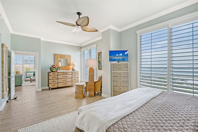 bedroom featuring crown molding, light hardwood / wood-style flooring, and ceiling fan