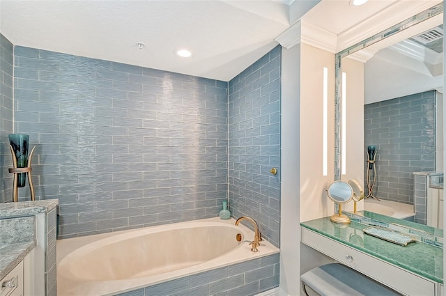 bathroom with a relaxing tiled tub, vanity, and toilet