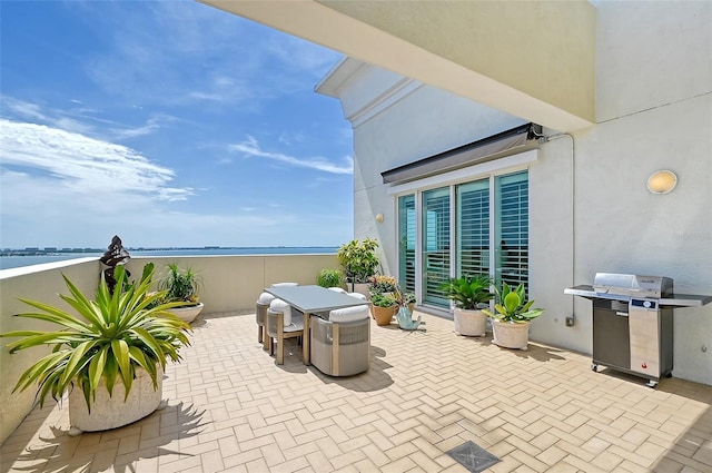 view of patio with a water view and area for grilling