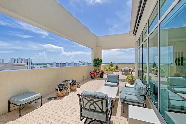 view of patio featuring a balcony and outdoor lounge area