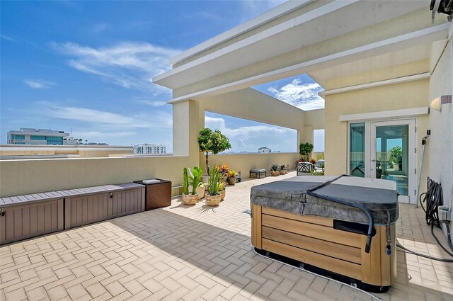 view of patio / terrace with a hot tub and french doors