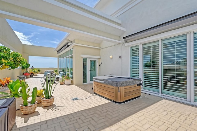 view of patio with a hot tub