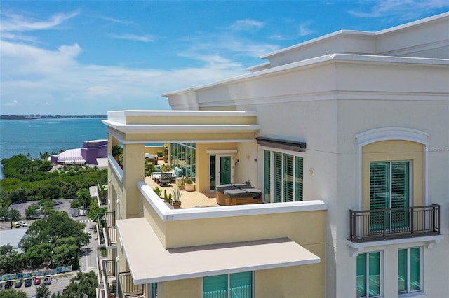 rear view of property with an outdoor hangout area and a water view