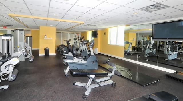 exercise room with a paneled ceiling