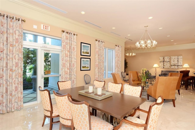 dining space featuring crown molding and a notable chandelier