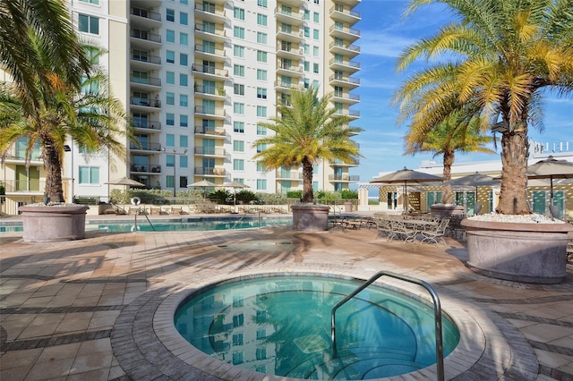 view of pool featuring a patio and a community hot tub