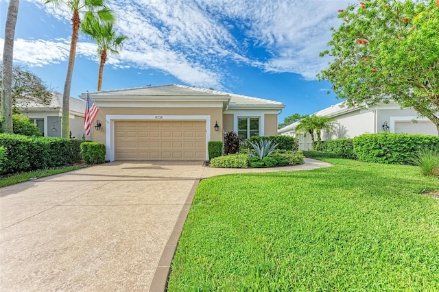 ranch-style home with a garage and a front yard