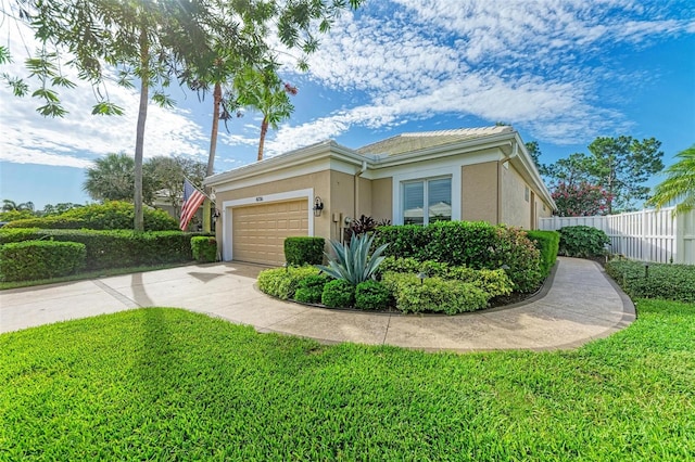 view of side of property featuring a garage and a lawn