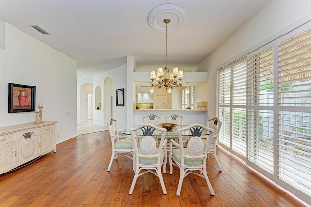 dining area featuring a notable chandelier and hardwood / wood-style floors