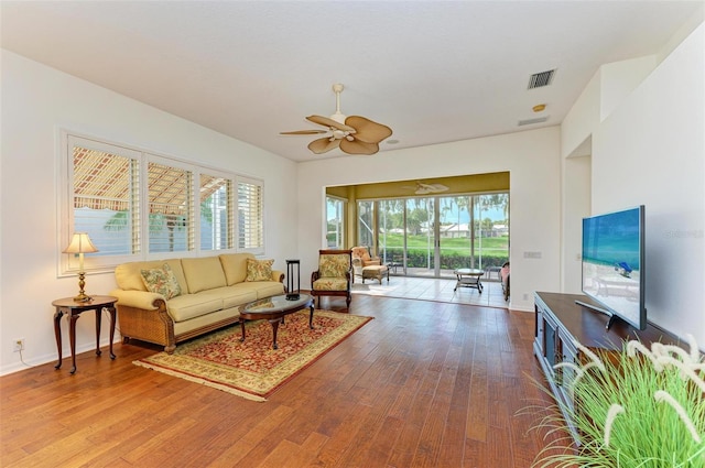 living room with hardwood / wood-style flooring and ceiling fan