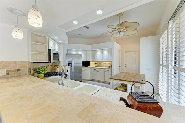 kitchen with decorative light fixtures, ceiling fan, tasteful backsplash, stainless steel appliances, and tile patterned flooring