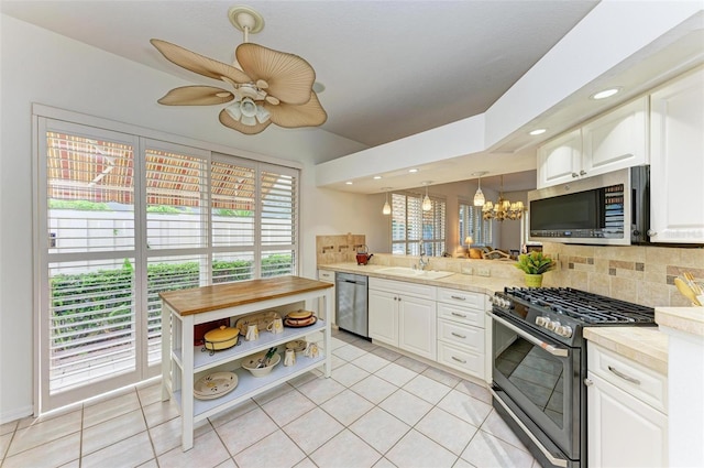 kitchen featuring light tile patterned flooring, tasteful backsplash, appliances with stainless steel finishes, and sink