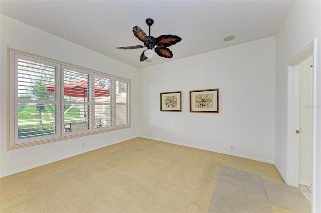 unfurnished room featuring light colored carpet and ceiling fan