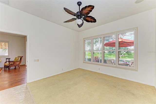 carpeted empty room with ceiling fan