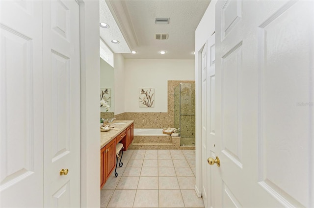 bathroom with vanity, tile patterned floors, a textured ceiling, and shower with separate bathtub