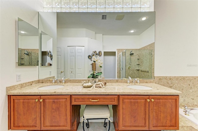 bathroom featuring shower with separate bathtub and dual vanity