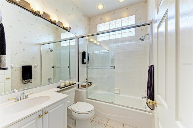 full bathroom featuring vanity, toilet, shower / bath combination with glass door, and tile patterned floors