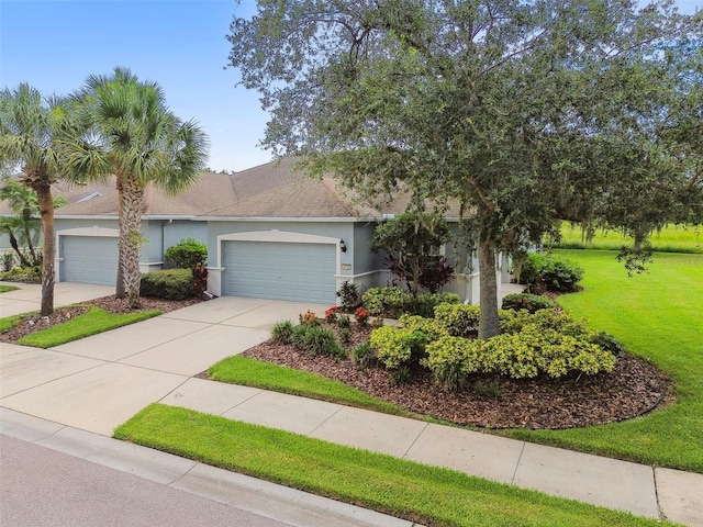 view of front of home featuring a garage and a front yard