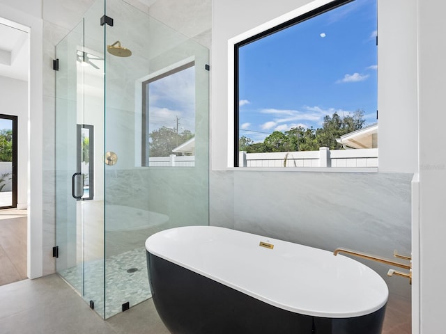 bathroom with plus walk in shower and concrete floors