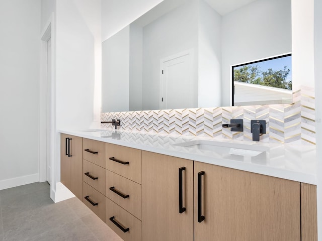 bathroom with vanity and tasteful backsplash