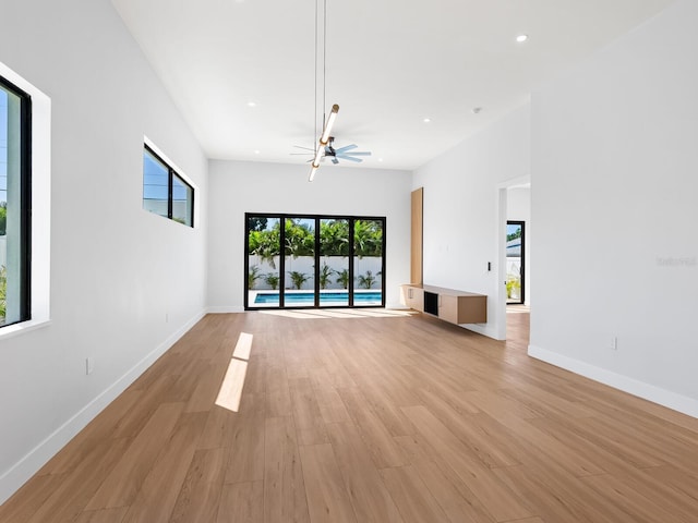 unfurnished living room with light hardwood / wood-style flooring and a wealth of natural light