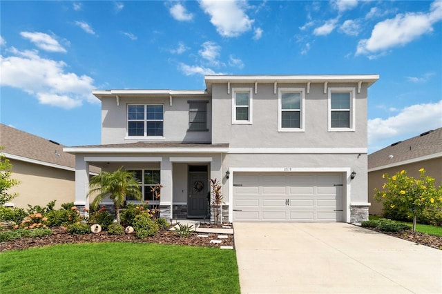 view of front of home with a front lawn and a garage