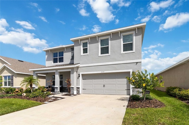 view of front facade with a garage, a front yard, and covered porch