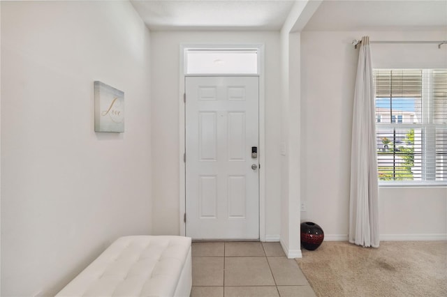 foyer entrance with light tile patterned flooring