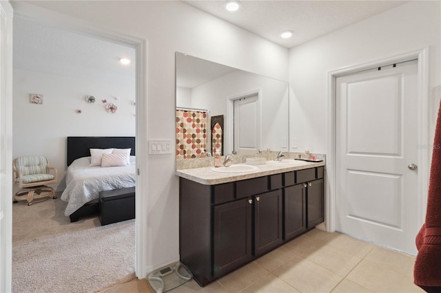 bathroom with tile patterned floors and vanity